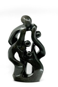 Beeld gezin 4 personen steen. Familie en geboorte kunst voor jubileum en goud zilver bruiloft. Beeld van vader, moeder en kind.